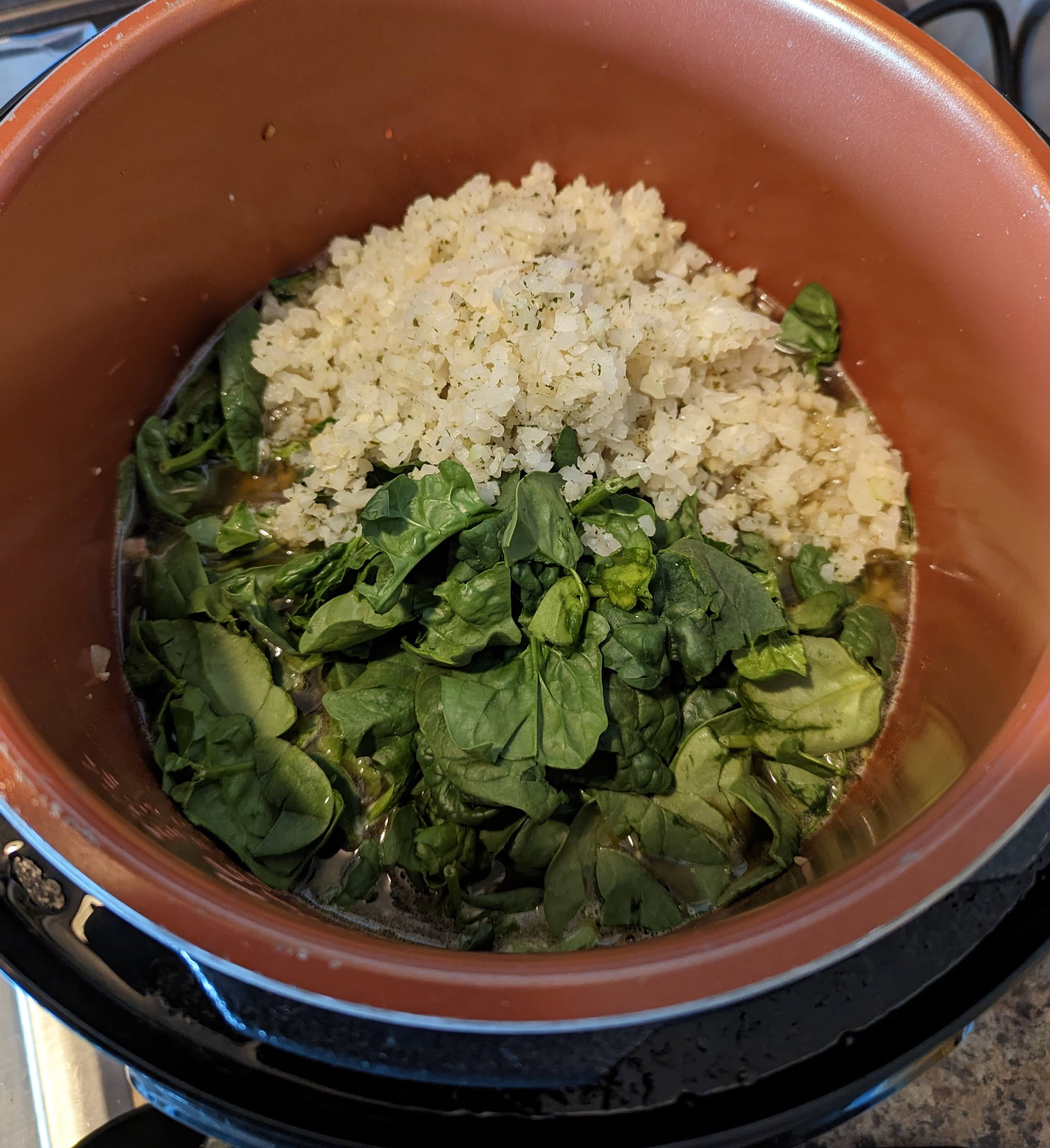 Add broth, spinach, and cauliflower rice.
